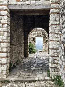 Stone arch passage inside Berat Castle with views over the surrounding landscape, visited on a Berat day tour from Tirana Albania