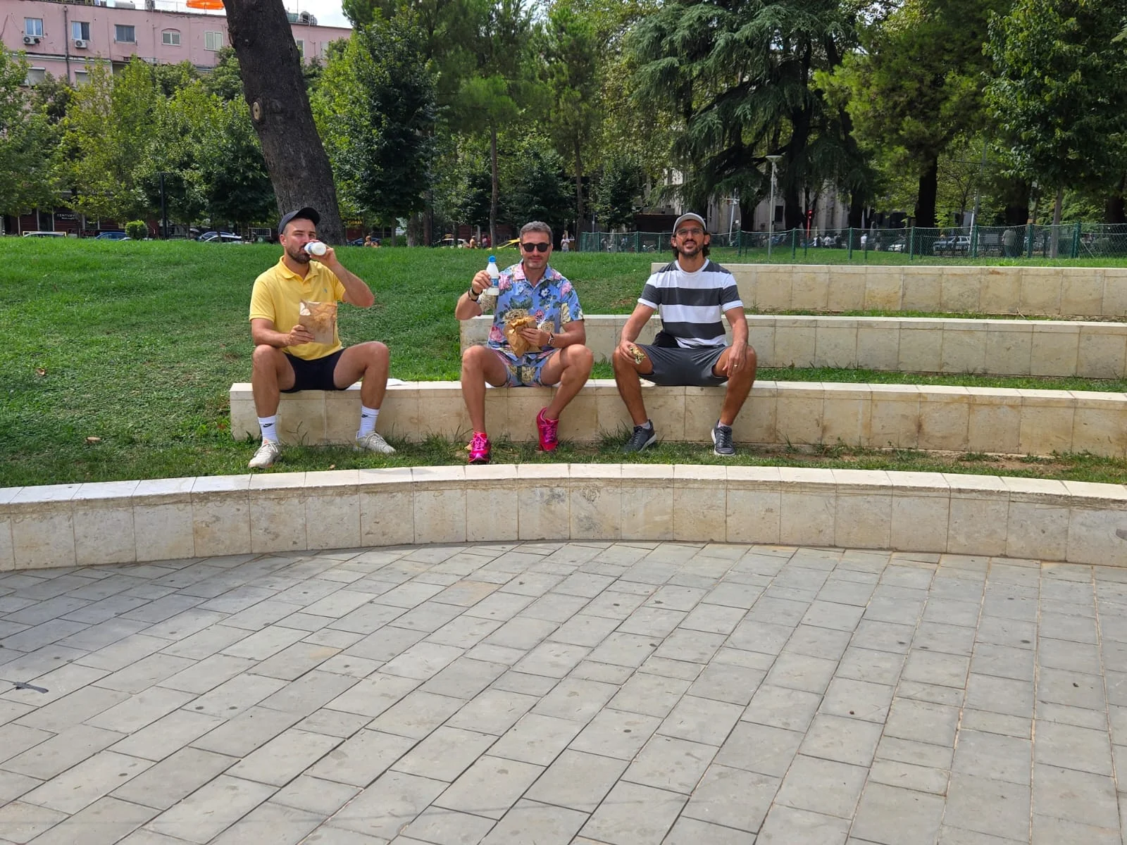 Guests tasting local snacks in a park during a Tirana food tour experience